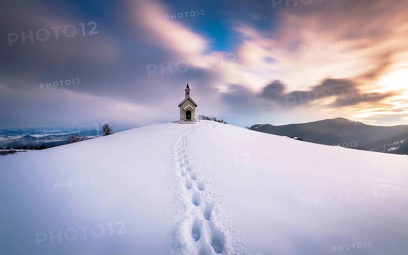 Footprints in fresh snow on a hill to a small chapel backlit in winter, AI generated, AI generated