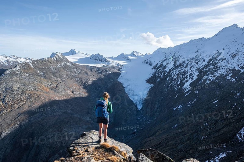 Hiker looking at mountain panorama and glacier, view of Gurgler Ferner with summit Hochwilde and Falschungsspitze, Oetztal Alps, Tyrol, Austria, Europe