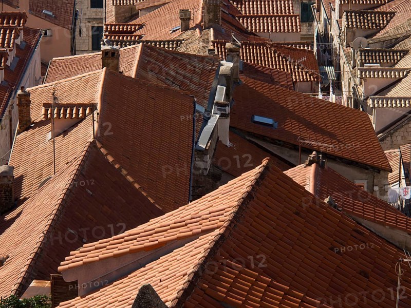 Close-up of tiled roofs in an old town showing narrow streets and densely built-up houses, the old town of Dubrovnik with historic houses, churches, red roofs and fortress walls, dubrovnik, coratia