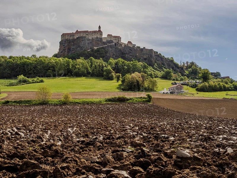 Clods of earth in farmland, Riegersburg Castle in the background, near Riegersburg, Styria, Austria, Europe