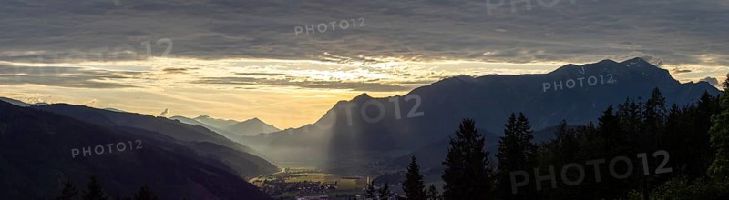 Sunlight falls on the Liesingtal valley and on the village of Traboch, Schoberpass federal road, panoramic photo, view from the lowlands, Leoben, Styria, Austria, Europe