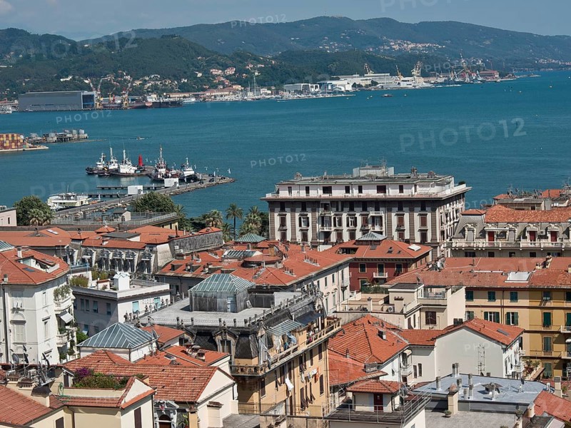 City panorama with red roofs, view of harbour and hills in the distance on a sunny day, Bari, Italy, Europe