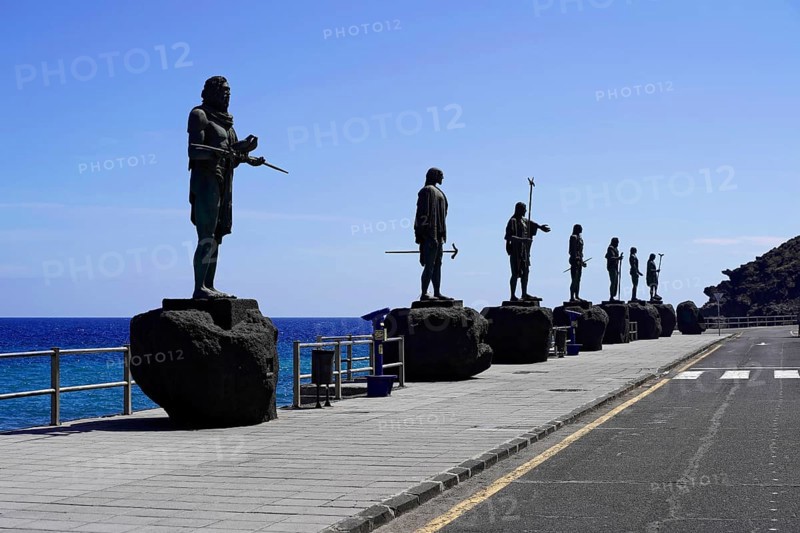 Statues of the Guanche Kings or Mencey Statues, in front Guanche King Adjona, promenade of Candelaria, Tenerife, Canary Islands, Spain, Europe, row of statues along a promenade with a view of the ocean under a clear sky, Europe