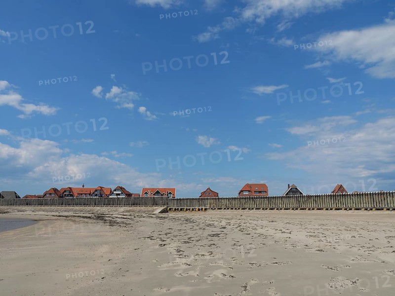Coastal landscape with a wide beach and traditional houses, Baltrum Germany