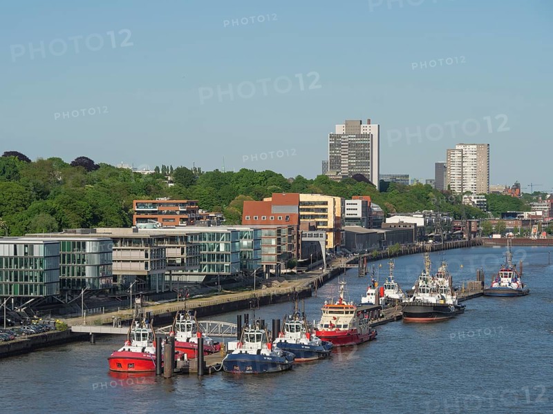 River section with modern buildings and numerous boats under a clear sky in the summer, beautiful city on the river with harbour, shipyards, houses and ships, Hamburg, Germany, Europe