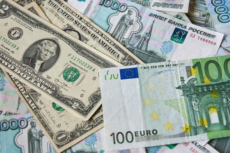 Background of paper bills dollars, euros and rubles. Currency exchange rate