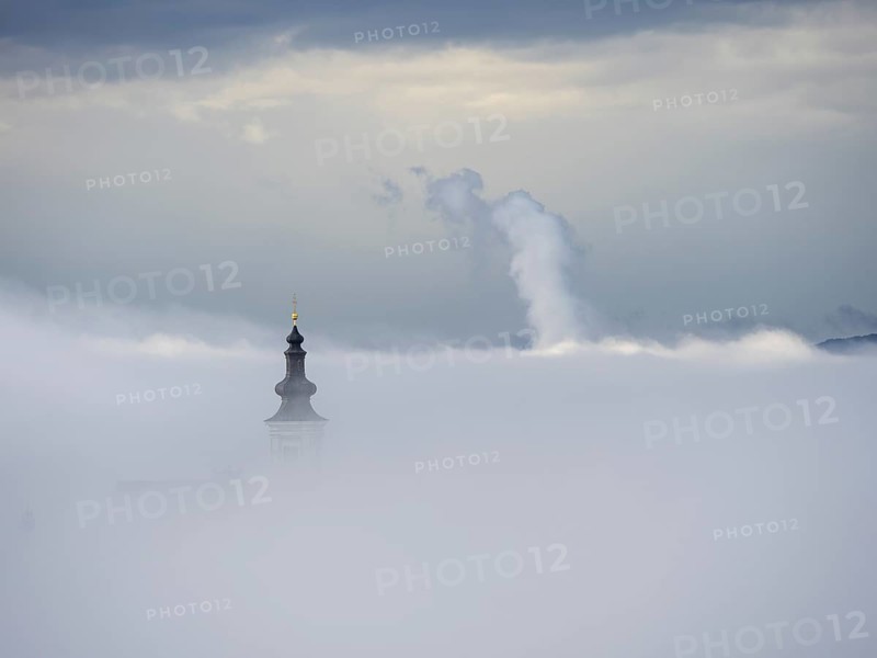 Church tower rises out of the morning mist, Frauenberg pilgrimage church, near Leibnitz, Styria, Austria, Europe