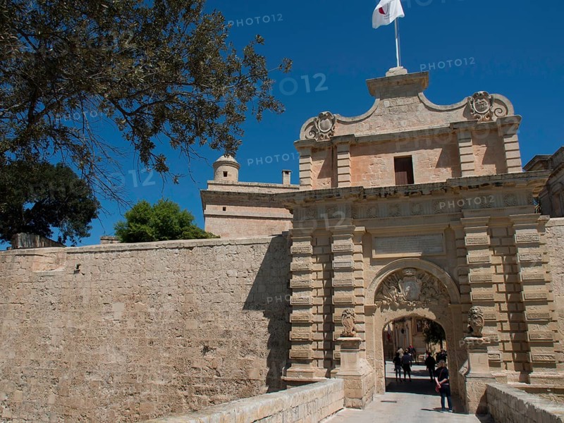 Large sandstone city gate with visitor access and historic charm under a blue sky, the town of mdina on the island of malta with historic houses, colourful balconies, magnificent churches, mdina, Malta, Europe