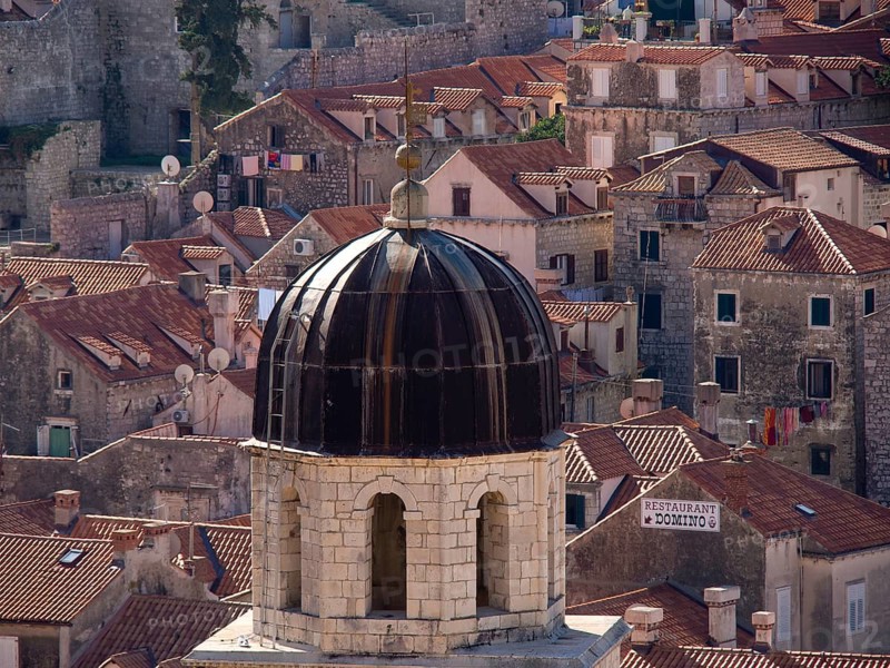 Domed roof of a church and surrounding old buildings with red roof tiles, the old town of Dubrovnik with historic houses, churches, red roofs and fortress walls, dubrovnik, coratia