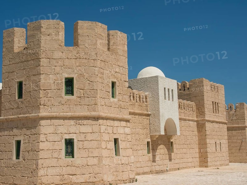 Stone fortress with high walls and towers under a clear blue sky, medieval ambience, Tunis in Africa with ruins from Roman times, modern mosques and blue and white houses in sidi-bou-said, Tunis, Tunisia, Africa