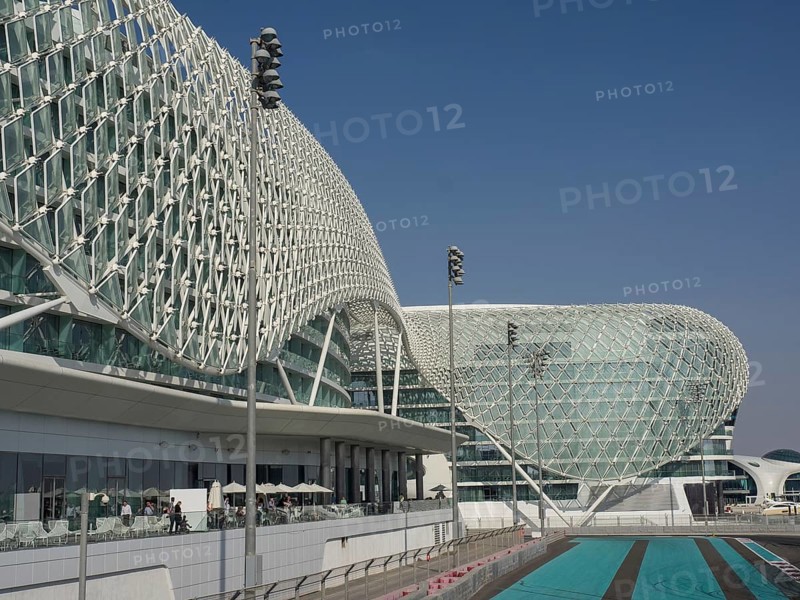 Building with modern grid structure, large windows and racetrack under blue sky, Abu Dhabi, United Arab Emirates, Asia