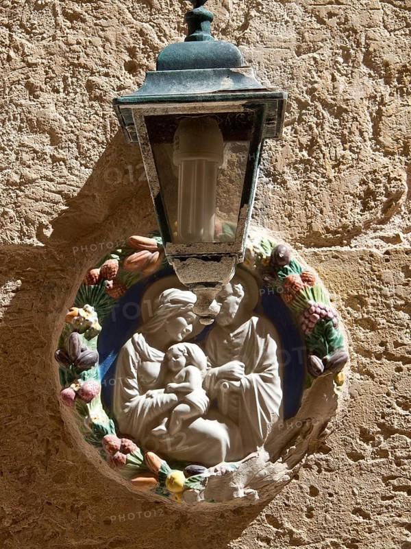 A religious wall decoration with a lamp on a stone wall, the town of mdina on the island of malta with historic houses, colourful balconies, magnificent churches, mdina, Malta, Europe