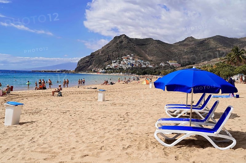 Sandy beach beach Playa de Las Teresitas, near San Andres, Tenerife, Canary Islands, Spain, Europe, Sunny sandy beach with blue deckchairs and sunshades, mountains in the background, people enjoying the sea, Europe