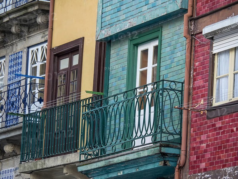 Facades of houses with colourful balconies, clotheslines and windows, old houses in the old town of Porto on the Douro, Porto, portugal