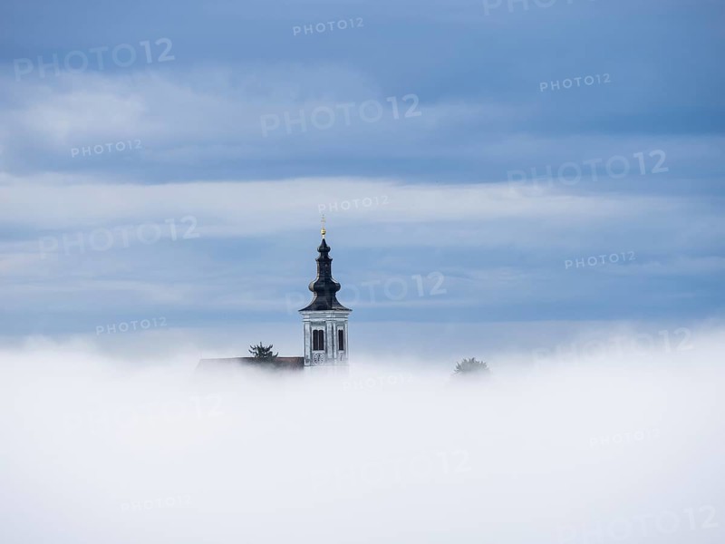 Church tower rises out of the morning mist, Frauenberg pilgrimage church, near Leibnitz, Styria, Austria, Europe