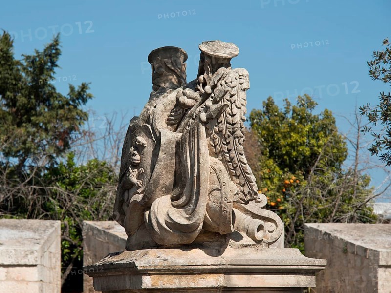 Stone sculpture of an eagle with outstretched wings in a natural setting with trees, the town of mdina on the island of malta with historic houses, colourful balconies, magnificent churches, mdina, Malta, Europe