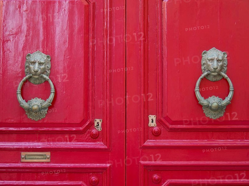 Two shiny red doors with antique, decorative lion's head door knockers, the town of mdina on the island of malta with historic houses, colourful balconies, magnificent churches, mdina, Malta, Europe
