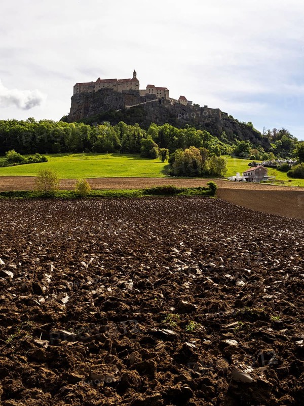 Clods of earth in farmland, Riegersburg Castle in the background, near Riegersburg, Styria, Austria, Europe