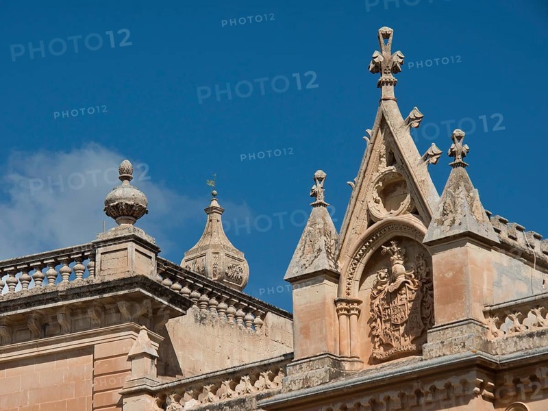 Gothic ecclesiastical architecture with ornate elements and towers under a blue sky, the town of mdina on the island of malta with historic houses, colourful balconies, magnificent churches, mdina, Malta, Europe