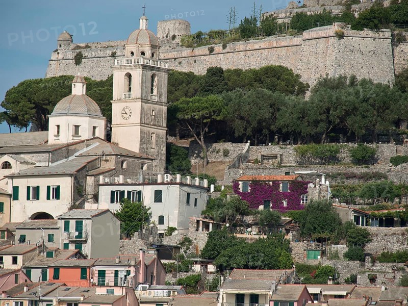 A mountain village with a church and a fortress, surrounded by colourful houses and trees, Bari, Italy, Europe