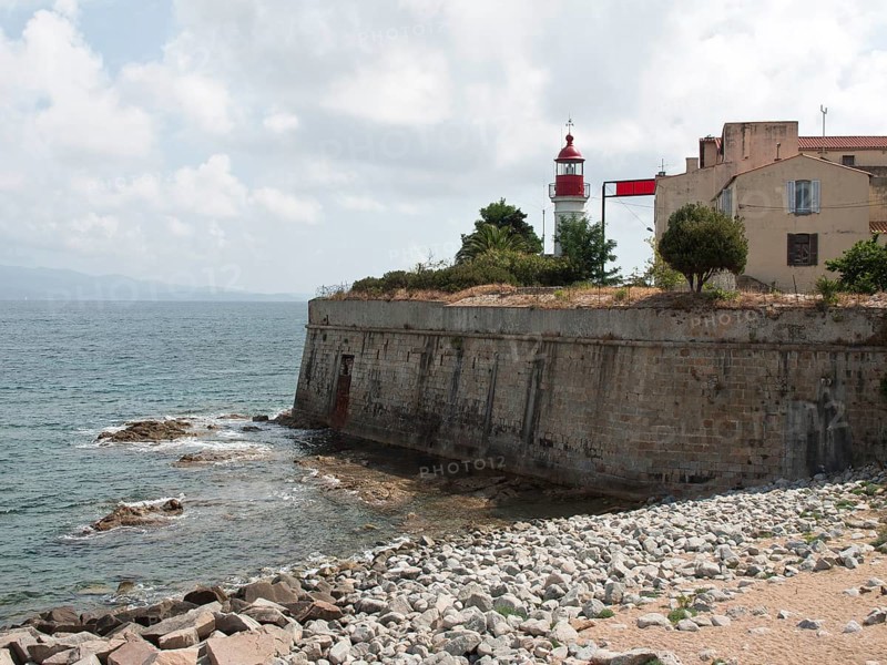Coastline with a lighthouse and old buildings on a rocky coast, Corsica, ajaccio, France, Europe