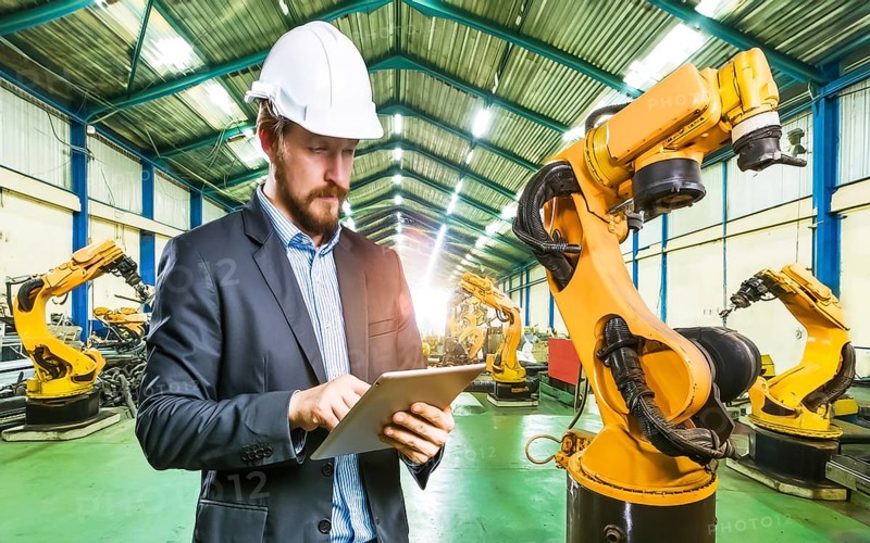 Industrial engineer with tablet control, automation of robot arms, intelligent monitoring, AI generated, AI generated