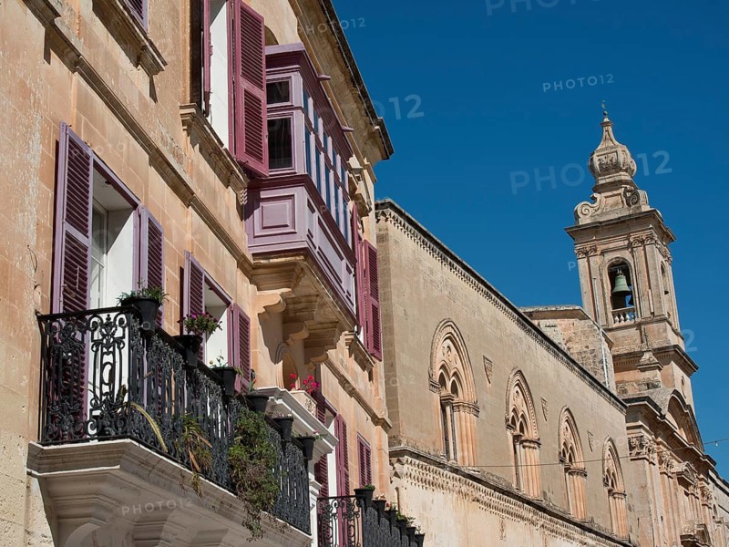 Row of historic buildings with balconies and shutters under a clear sky, the town of mdina on the island of malta with historic houses, colourful balconies, magnificent churches, mdina, Malta, Europe