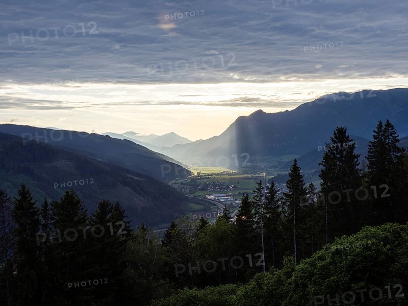 Sunlight falls on the Liesingtal valley and the village of Traboch, Schoberpass federal road, view from the lowlands, Leoben, Styria, Austria, Europe