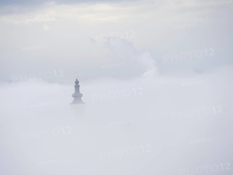 Church tower rises out of the morning mist, Frauenberg pilgrimage church, near Leibnitz, Styria, Austria, Europe