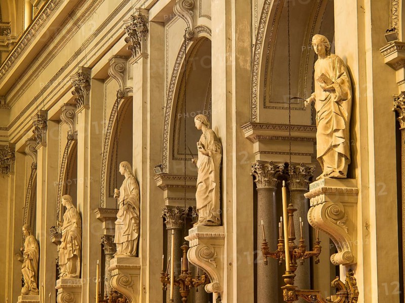 Detailed statues in a baroque church with golden elements and a sacred atmosphere, palermo in sicily with an impressive cathedral, monuments and old houses with balconies, palm trees and flowers in italy, palermo, sicily