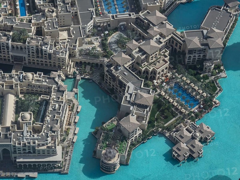 Aerial view of a large building complex with several swimming pools and turquoise-coloured water in a modern architecture, Dubai, Arab Emirates