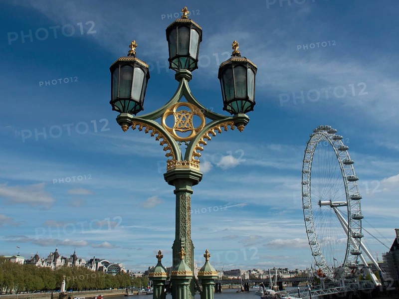 Decorated street lamp against a clear sky with the London Eye in the background, London, England, United Kingdom, Europe