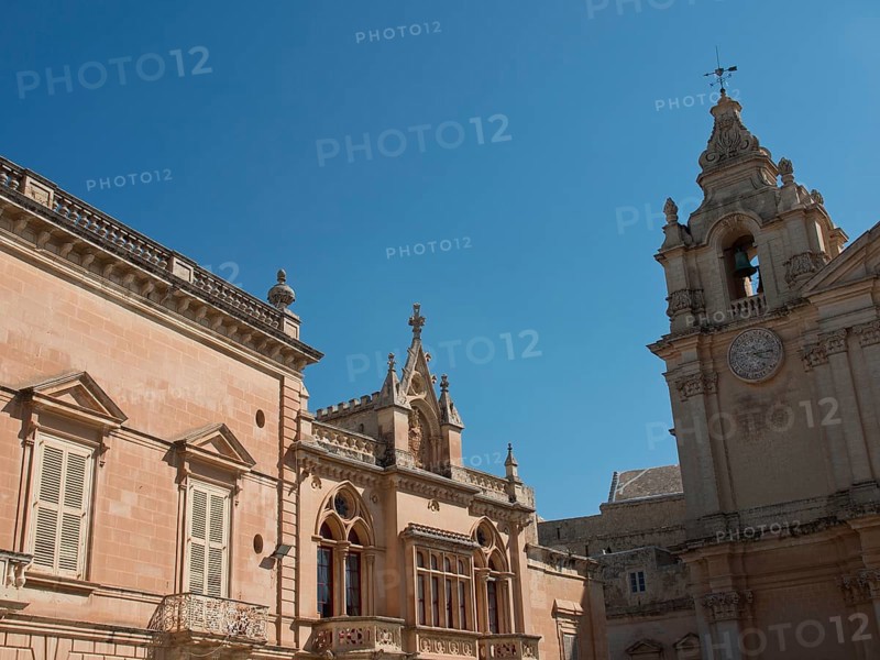 Historic buildings and a bell tower under a clear blue sky, the town of mdina on the island of malta with historic houses, colourful balconies, magnificent churches, mdina, Malta, Europe