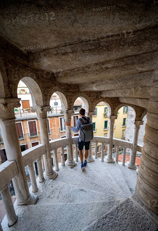 Young man on the spiral staircasePalazzo Contarini del Bovolo, Palace with spiral staircase, Venice, Veneto, Italy, Europe