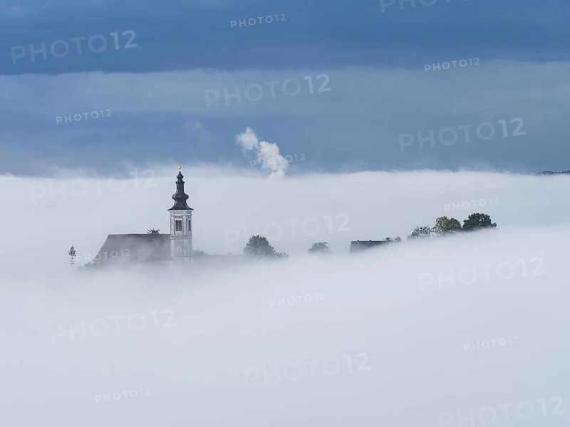 Church tower rises out of the morning mist, Frauenberg pilgrimage church, near Leibnitz, Styria, Austria, Europe