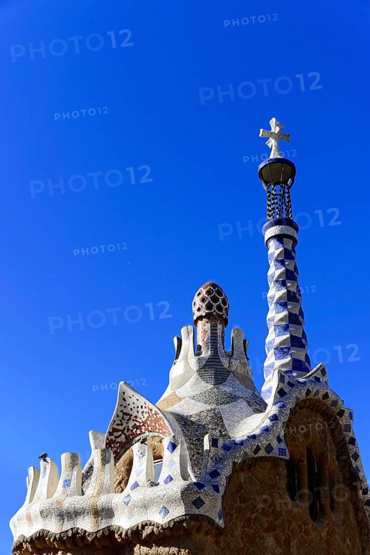 Antoni Gaudi, Park Guell, UNESCO World Heritage Site, Barcelona, Catalonia, Spain, Europe, An artistically designed tower with a mosaic roof against a bright blue sky, Europe