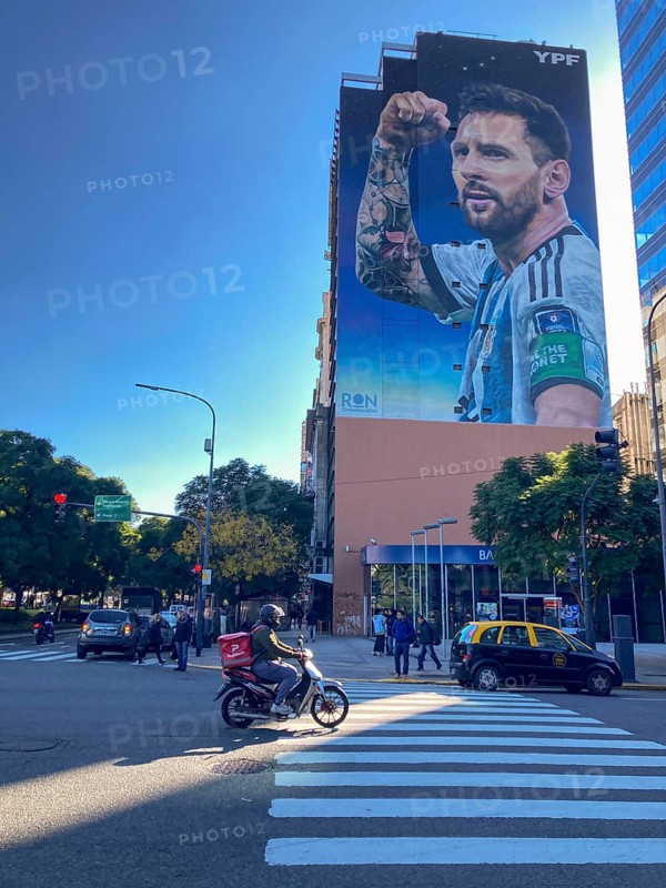 Street scene with giant mural showing Lionel Messi in winning pose, Buenos Aires, Argentina, South America