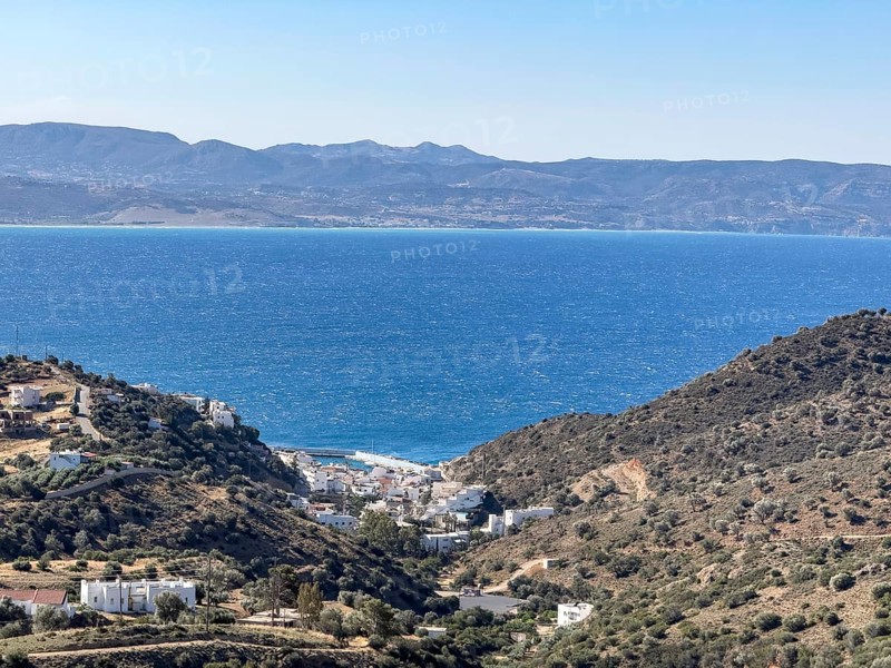 View of in the foreground former fishing village with sheltered safe harbour on the south coast of the island of Crete on the Gulf of Messara on the Libyan Sea Mediterranean, Agia Galini, Crete, Greece, Europe