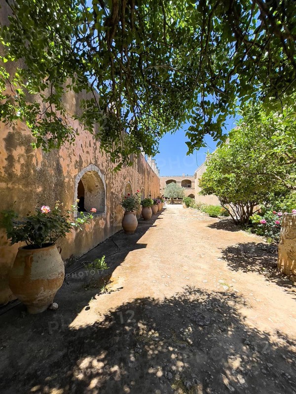 View of the inner courtyard of Arkadi Monastery left Archway in front of historical living quarters of monks with monks' cells Monks' cells Inner courtyard of the UNESCO World Heritage Site Moni Arkadi Orthodox Monastery Arkadi Monastery from the early Middle Ages, important national monument National shrine on the island of Crete, Arkadi, Armnatos, Crete, Greece, Europe