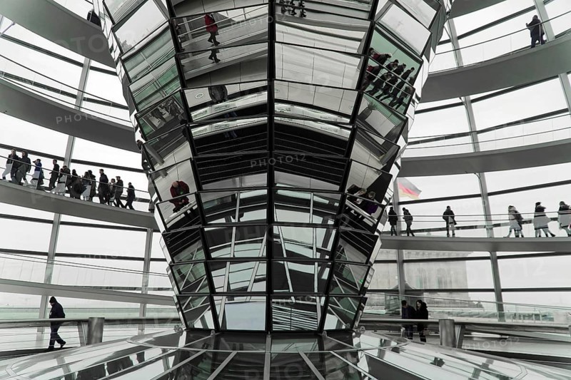 The dome of the Reichstag in Berlin. The architect Sir Norman Foster designed the steel and glass structure. Berlin, Berlin, Germany, Europe, people in an ultra-modern, glass structure with impressive architecture characterised by reflective surfaces, the dome of the Berlin Reichstag. Berlin, Europe