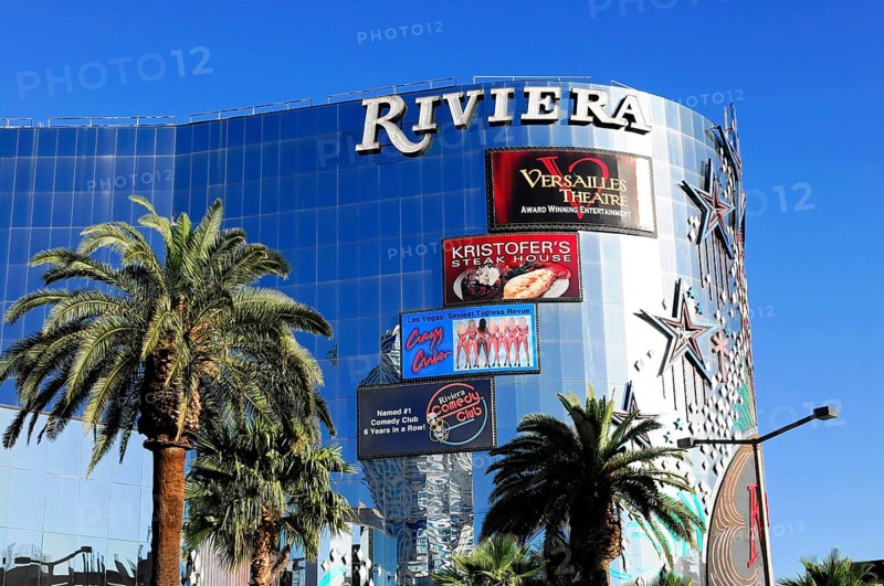 Las Vegas, Nevada, USA, North America, Shiny building in Las Vegas named Riviera surrounded by palm trees and billboards in front of a clear sky, Las Vegas Strip, North America