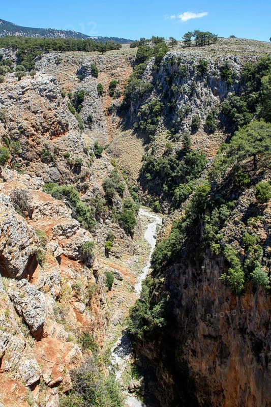 View to the north-east from the bridge over the deep, narrow Aradena Gorge to steep, rugged rocks, at the bottom of the picture hiking trail through the Aradena Gorge, Aradena, Crete, Greece, Europe