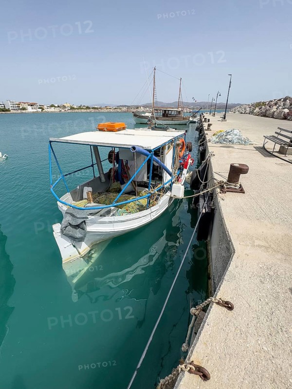 Fishing boat moored to quay wall in Kokkinos Pyrgos harbour, fishing nets on board, Kokkinos Pyrgos, Crete, Greece, Europe