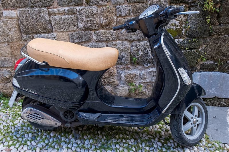 Black Vespa in front of an old stone wall, Rhodes, Greece, Europe