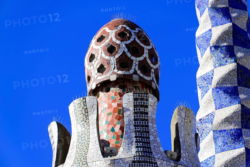 Antoni Gaudi, Park Guell, UNESCO World Heritage Site, Barcelona, Catalonia, Spain, Europe, Close-up of an ornately decorated tower with mosaic patterns against a clear blue sky, Europe