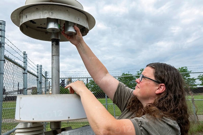 Dearborn, Michigan, Rebecca Robak, an environmental technician, checks air quality instruments at a monitoring station operated by Michigan's Department of Environment, Great Lakes, and Energy. (EGLE) .. The station, at Salina School, is in the heavily industrialized southwest Detroit area