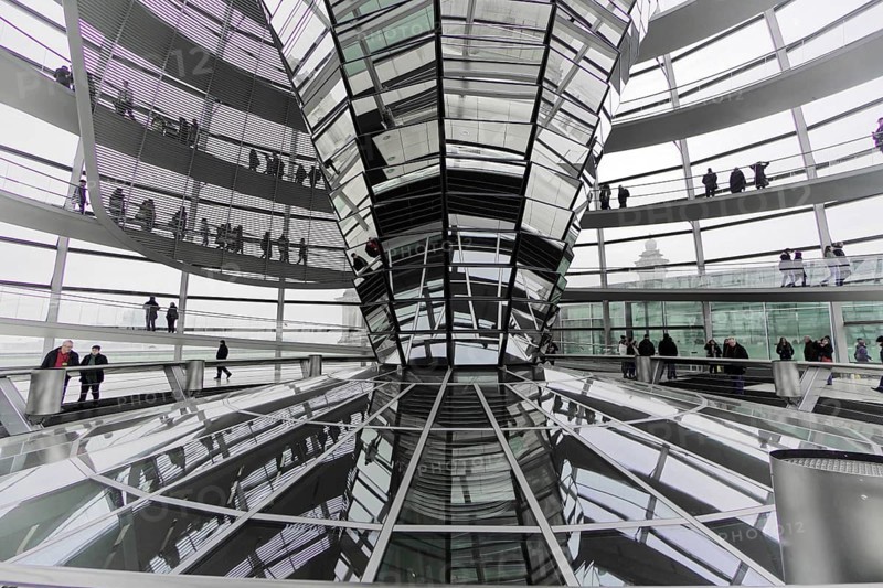 The dome of the Reichstag in Berlin. The architect Sir Norman Foster designed the steel and glass structure. Berlin, Berlin, Germany, Europe, Interior view of an ultra-modern glass construction with reflective surfaces and people walking through the space, The dome of the Berlin Reichstag. Berlin, Europe