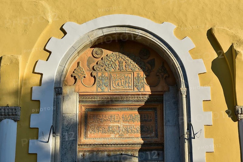 Ottoman library, detail of a historic archway with inscriptions and ornaments, above a yellow wall piece with shadows, Rhodes Old Town, Rhodes Town, Rhodes, Dodecanese, Greek Islands, Greece, Europe
