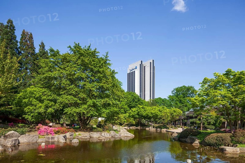 Japanese garden in the Planten un Blomen park with Radisson Blu Hotel and park pond in spring, Hamburg, Germany, Europe