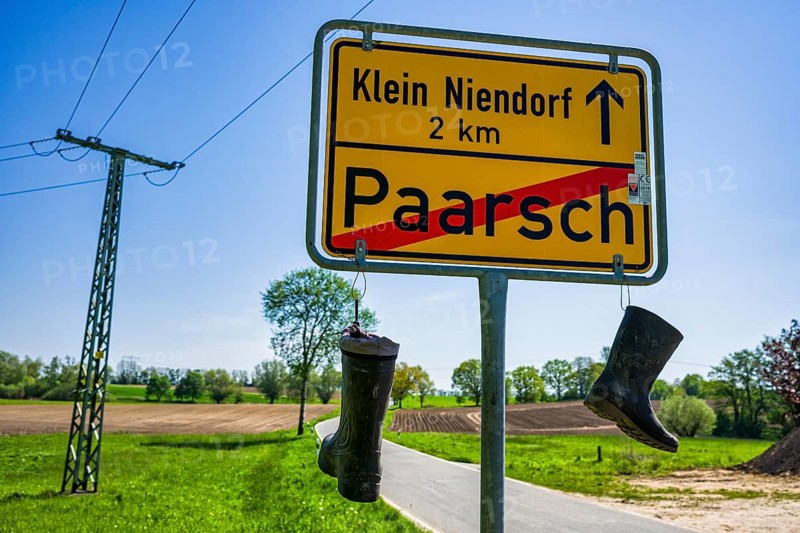 Boots on town sign, farmers' protest, Paarsch, Rome, Mecklenburg-Western Pomerania, Germany, Europe